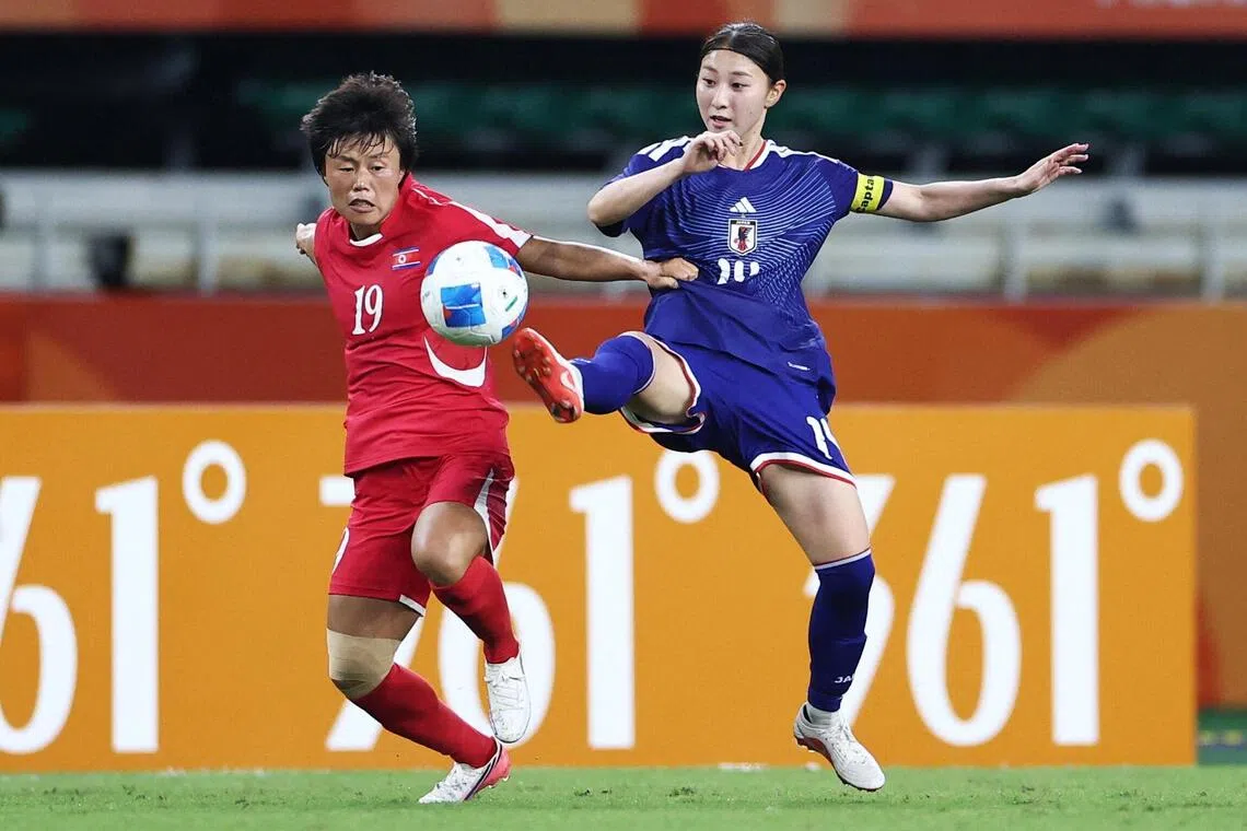 Japan’s Shiokoshi Yuzuho fighting for the ball with North Korea’s Choe Kum Ok in the Asian Games women’s football final at Shizuoka Stadium on Oct 2.