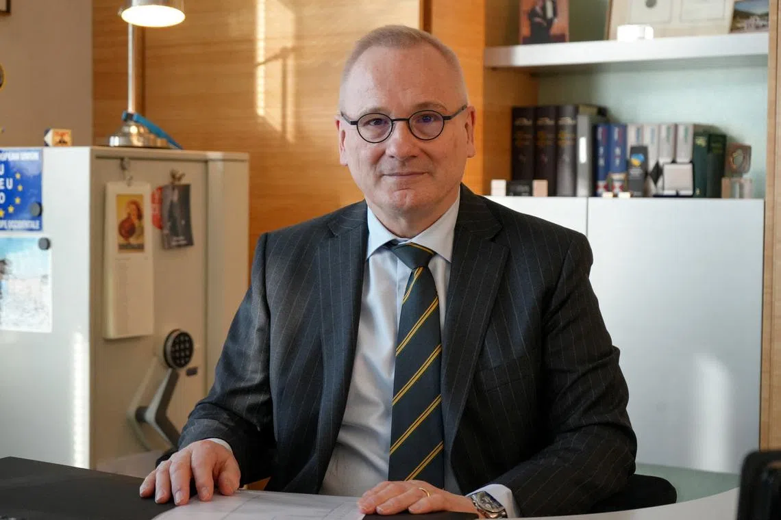 Robert in den Bosch, the Disarmament Ambassador and Permanent Representative to the Conference on Disarmament of the Kingdom of the Netherlands in Geneva, and Chair of the Convention on Certain Conventional Weapons Group of Governmental Experts on Emerging Technologies in Lethal Autonomous Weapons Systems, sits at a desk in his office in Geneva, Switzerland February 25, 2026. REUTERS/Olivia Le Poidevin