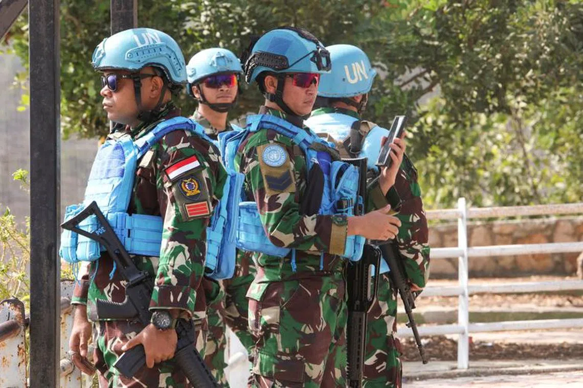 FILE PHOTO: Members of the United Nations peacekeepers (UNIFIL) stand together in Khiam, near the border with Israel, in southern Lebanon October 9, 2023. REUTERS/Aziz Taher/File Photo