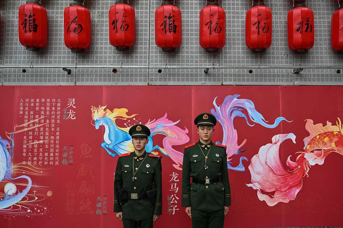 Chinese paramilitary policemen standing guard as people visit the Yu Garden during the fourth day of the Lunar New Year of the Dragon in Shanghai on Feb 13, 2024. 