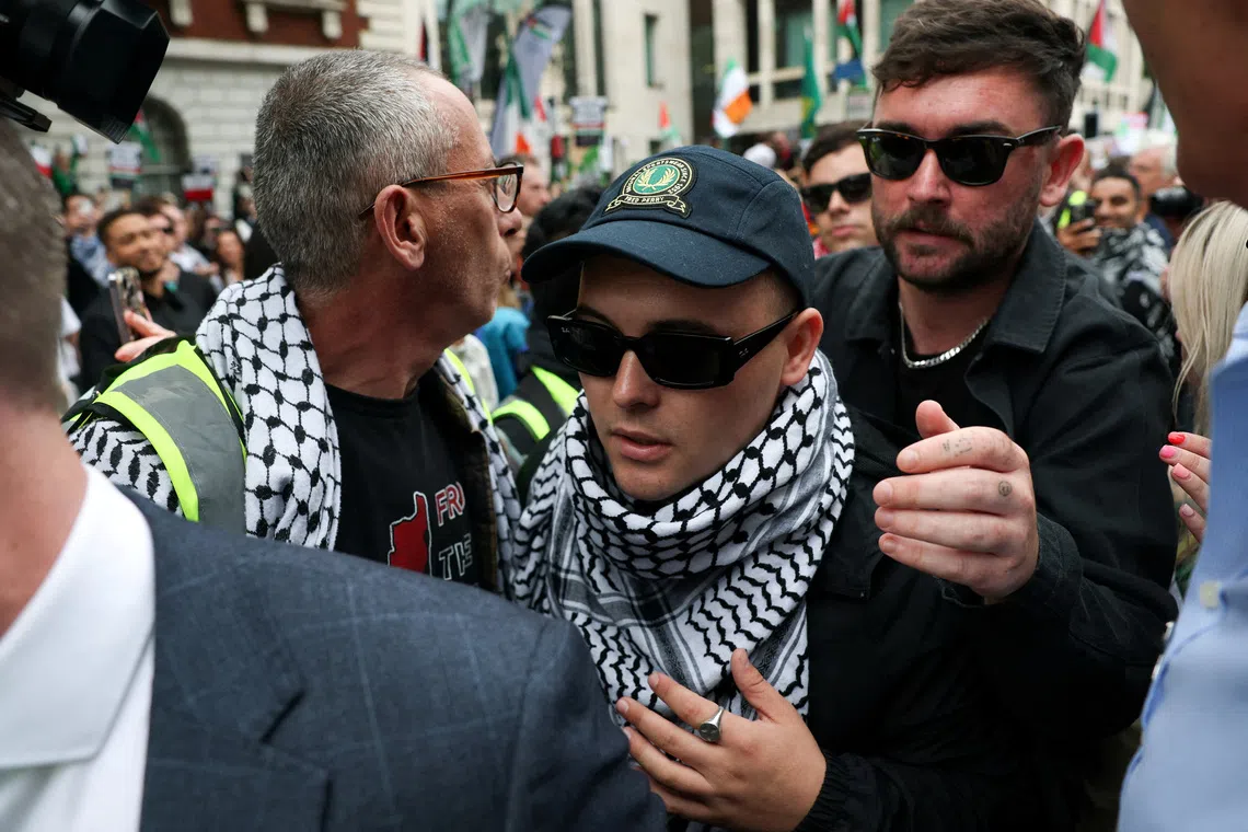 Kneecap frontman Liam O'Hanna walking outside a court in London in August 2025, after being charged with a terrorism offence.