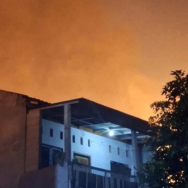 Smoke billows behind a building after a fire broke out at a liquefied petroleum gas filling station near a residential area, in Bekasi, Indonesia, April 1, 2026, in this screengrab from video obtained from social media. @AnaknyaKimSabu via X/via REUTERS