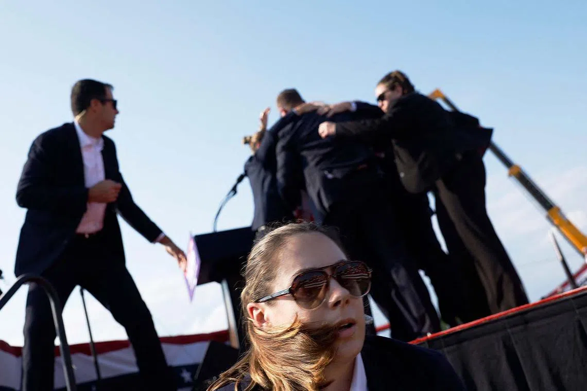 Republican presidential candidate former President Donald Trump is rushed offstage by U.S. Secret Service agents after being grazed by a bullet during a rally.