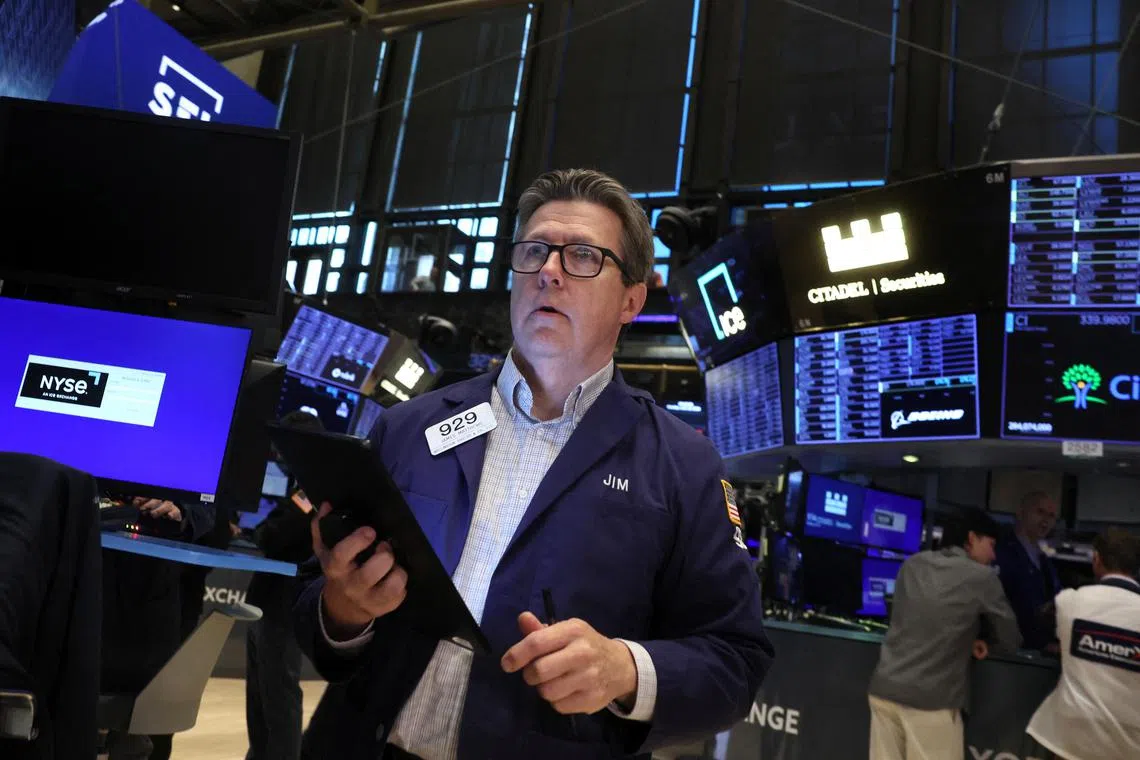 Traders work on the floor of the New York Stock Exchange, in New York City.