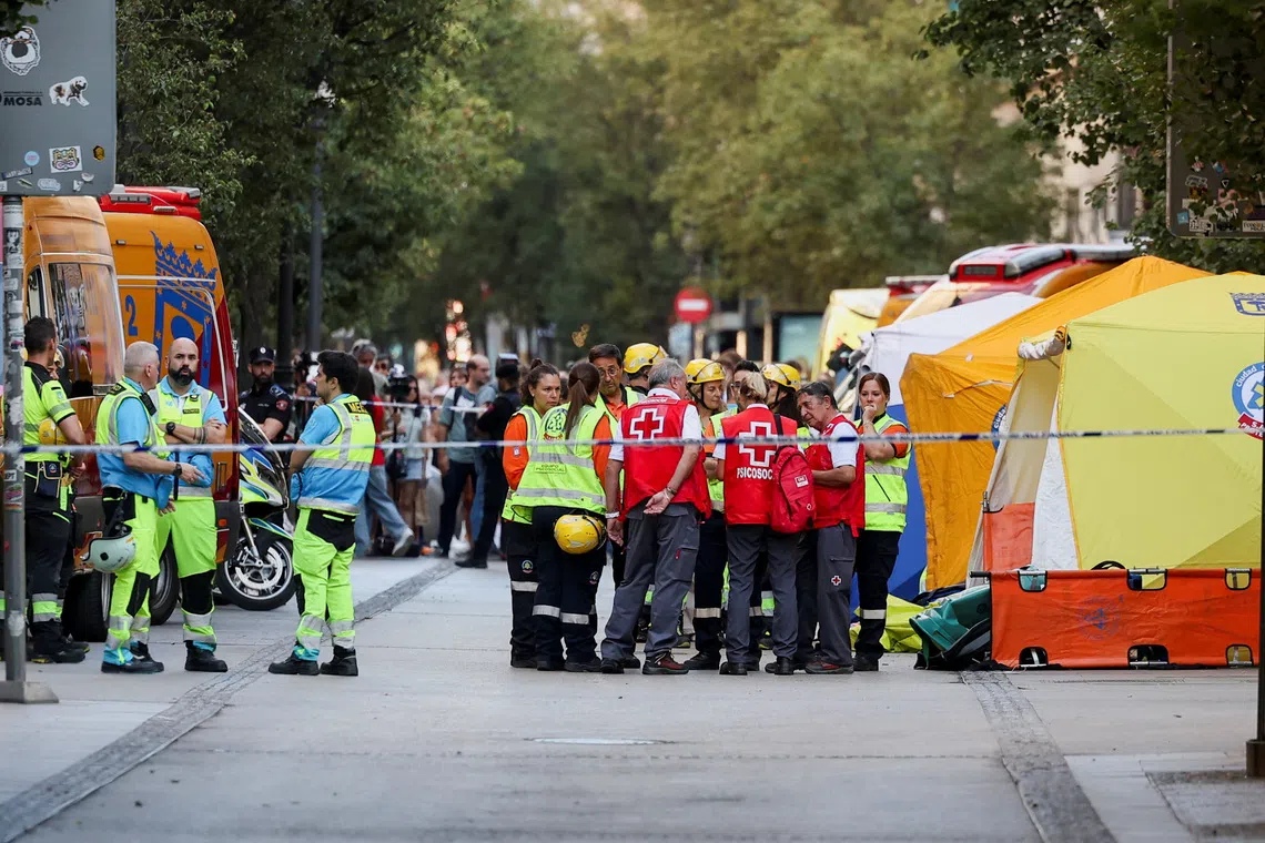 Emergency responders work at the site of a building collapse in central Madrid, Spain, October 7, 2025. REUTERS/Juan Medina