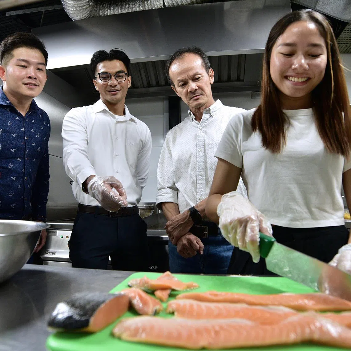 asgryouth - Nur Adilah and Clyde presenting their idea to salvage and repurpose meat off-cuts to Mr Joseph Soh, café owner, with Mr Dennis Lim, their lecturer and project supervisor, observing at the side.



Photos by NYAA