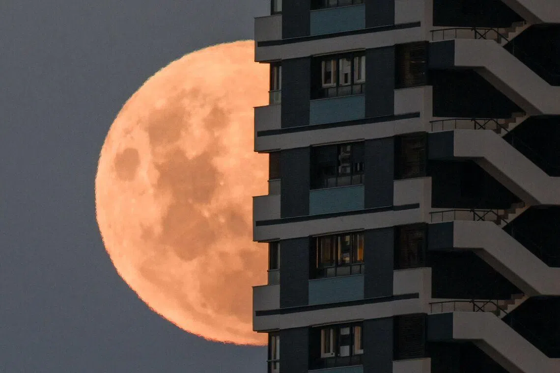 The moon rising in its waxing gibbous phase behind a building in Buenos Aires, Argentina on March 2, 2026. 
