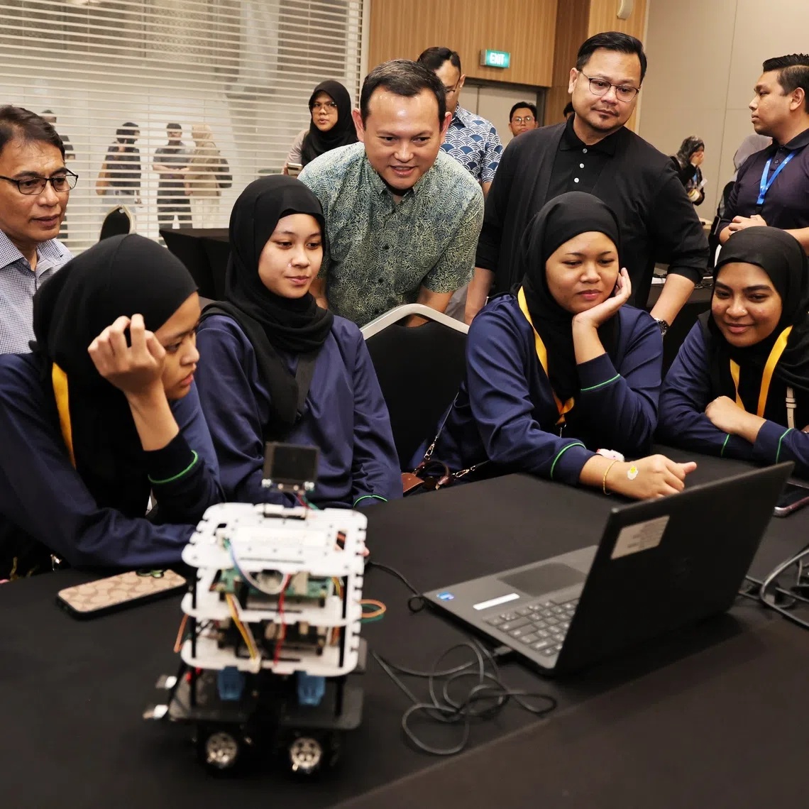 Acting Minister-in-charge of Muslim Affairs Zaqy Mohamad interacting with participants at a programming workshop at the Singapore University of Technology and Design on Aug 29.