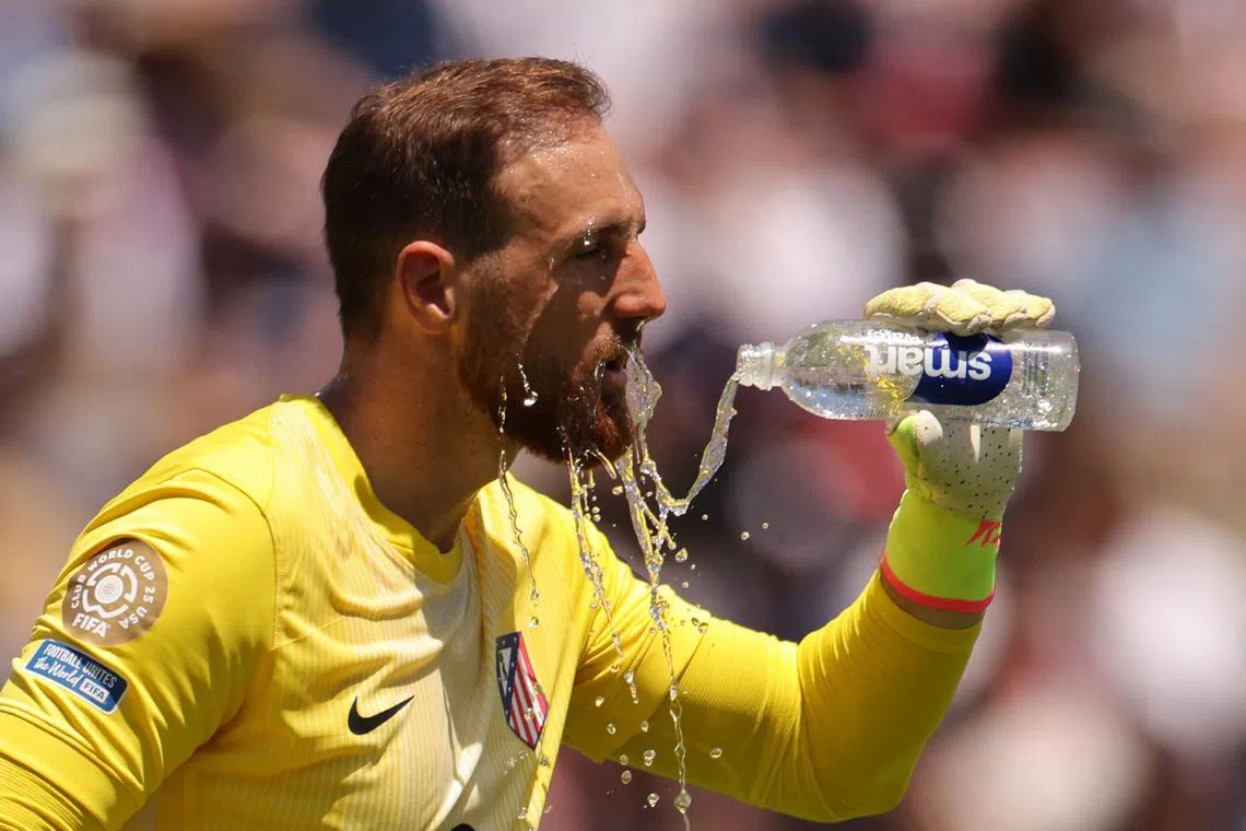 Atletico Madrid's Jan Oblak pouring water on his face to cool down, during a break in play in Pasadena, California, on June 15.