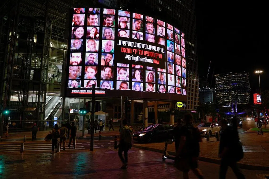 FILE PHOTO: Pictures of hostages held in Gaza, who were seized from southern Israel on October 7 by Hamas gunmen during a deadly attack, are displayed in Tel Aviv, Israel, November 15, 2023. REUTERS/Ammar Awad/File Photo