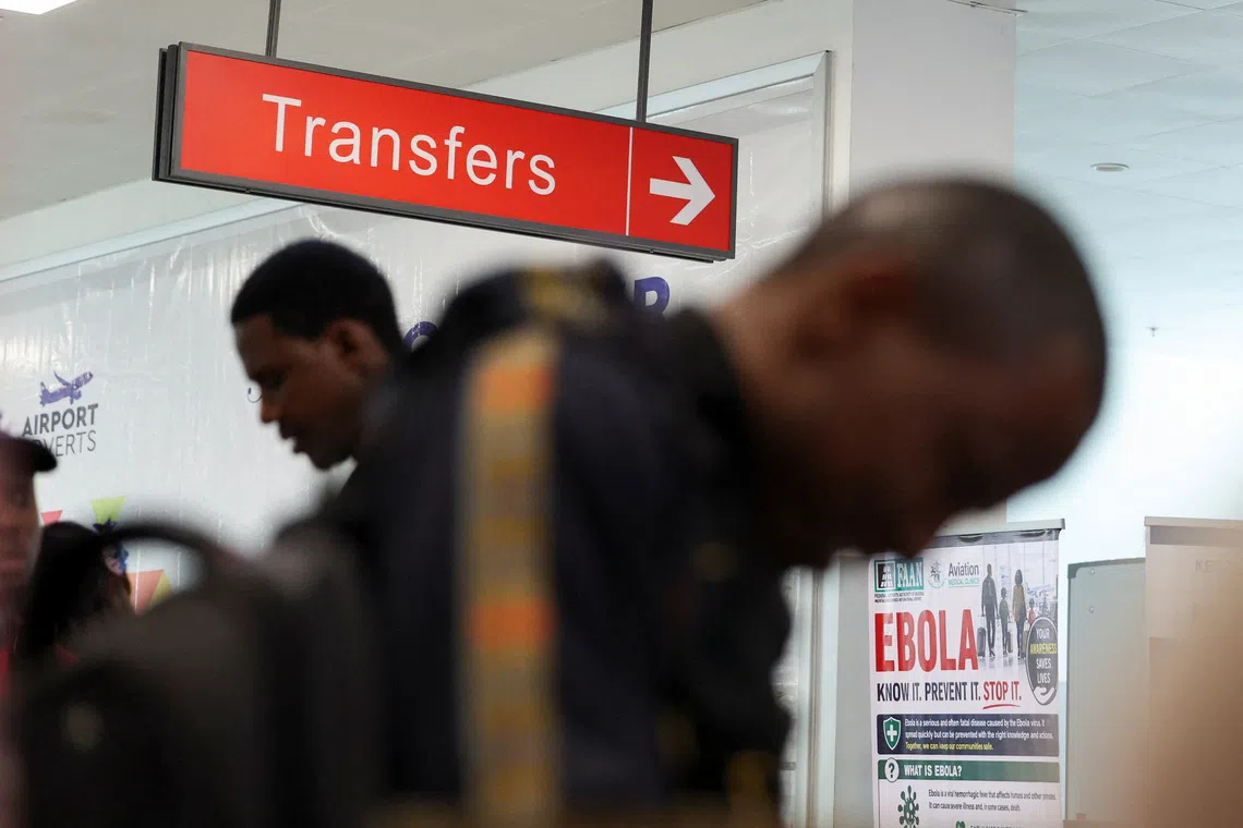 Travellers arrive for health screening at Murtala Muhammed International Airport following reports of an Ebola case in Nigeria on Oct 22.