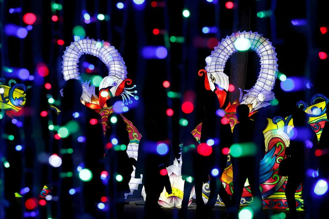 People visit an illuminated walk-through trail featuring larger-than-life lantern illuminated sculptures, light installations, and light projections which has been set up for the Christmas season at Verdala Palace outside Rabat, Malta, Dec 11, 2022. 