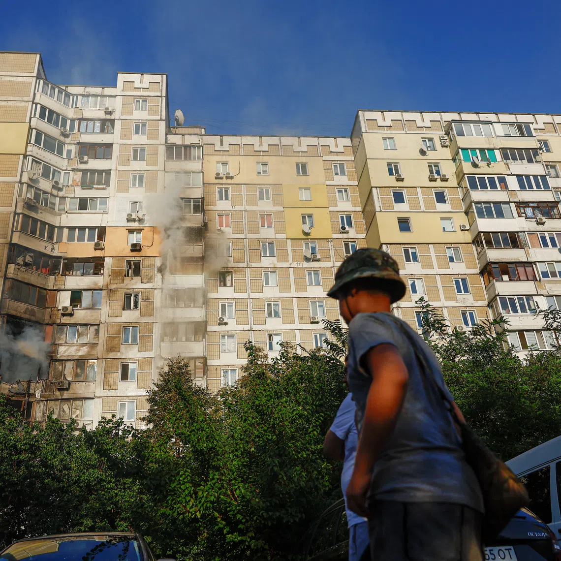 Residents gather at the site of a residential building hit during a Russian jet-powered drone strike, amid Russia's attack on Ukraine, in Kyiv, Ukraine, September 27, 2026. REUTERS/Valentyn Ogirenko