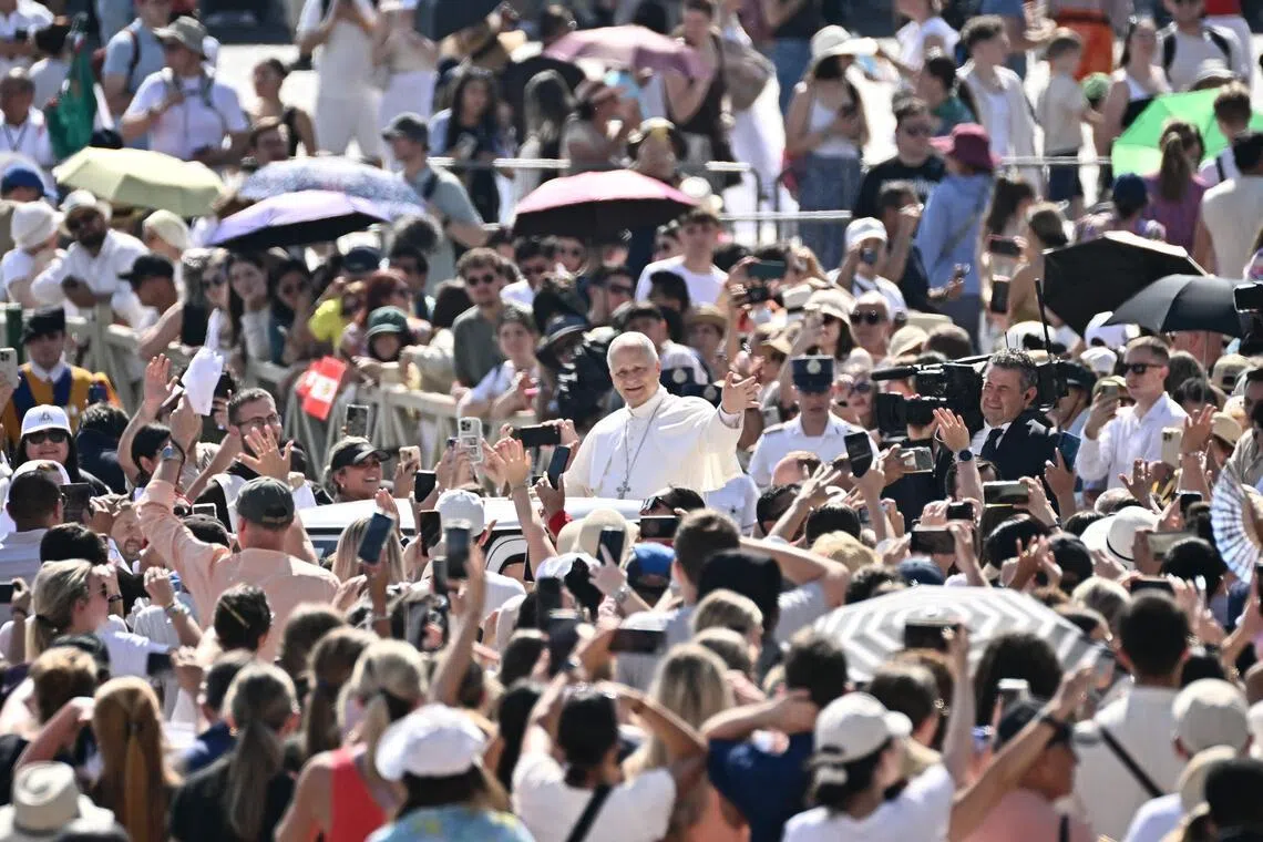 Pope Leo XIV waves to the crowd during the weekly general audience at St Peter's Square in The Vatican on June 24, 2026. (Photo by Filippo MONTEFORTE / AFP)