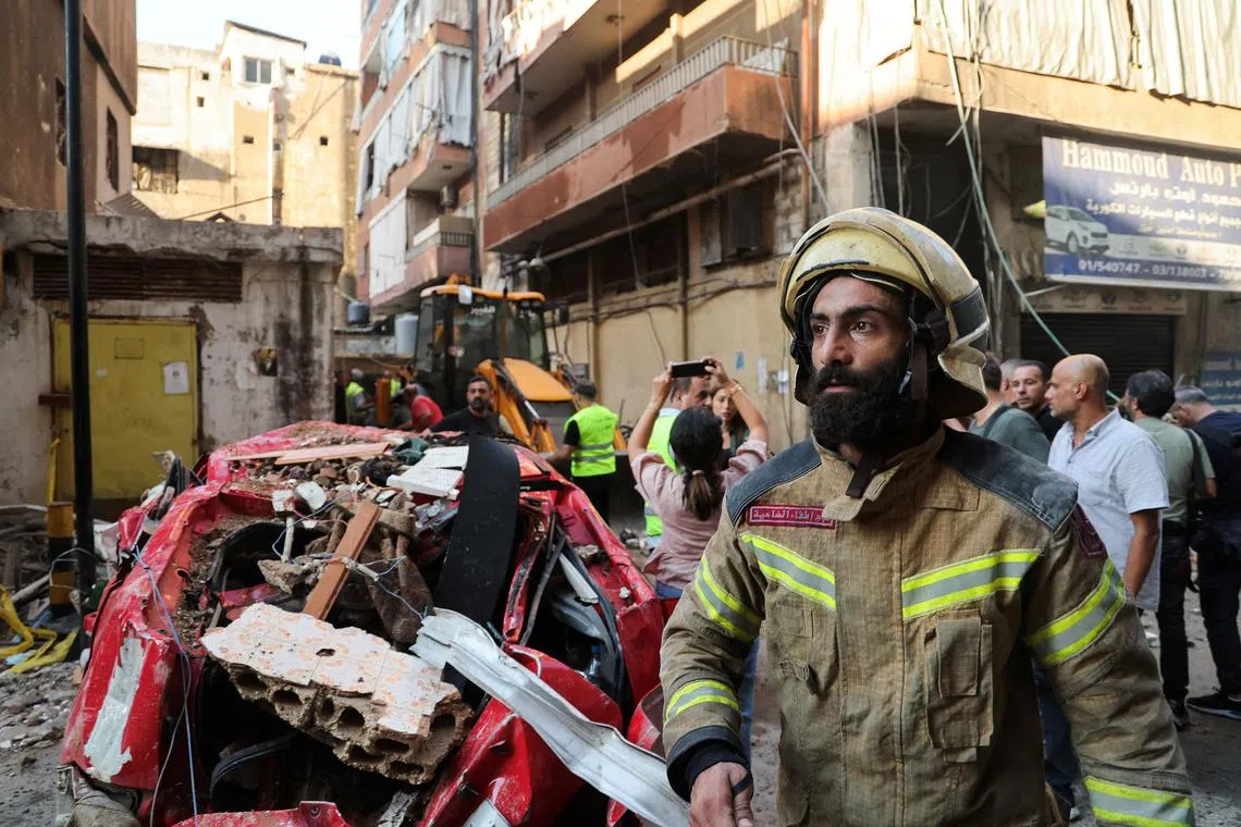 A firefighter working at the site of an Israeli strike, in Beirut's southern suburbs, on Sept 24.