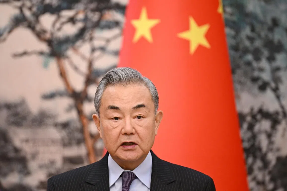 FILE PHOTO: China’s Foreign Minister Wang Yi  speaks during a joint briefing with French Foreign Minister Jean-Noel Barrot (not pictured) at the Diaoyutai State Guesthouse in Beijing, China on March 27, 2025. GREG BAKER/Pool via REUTERS/File photo