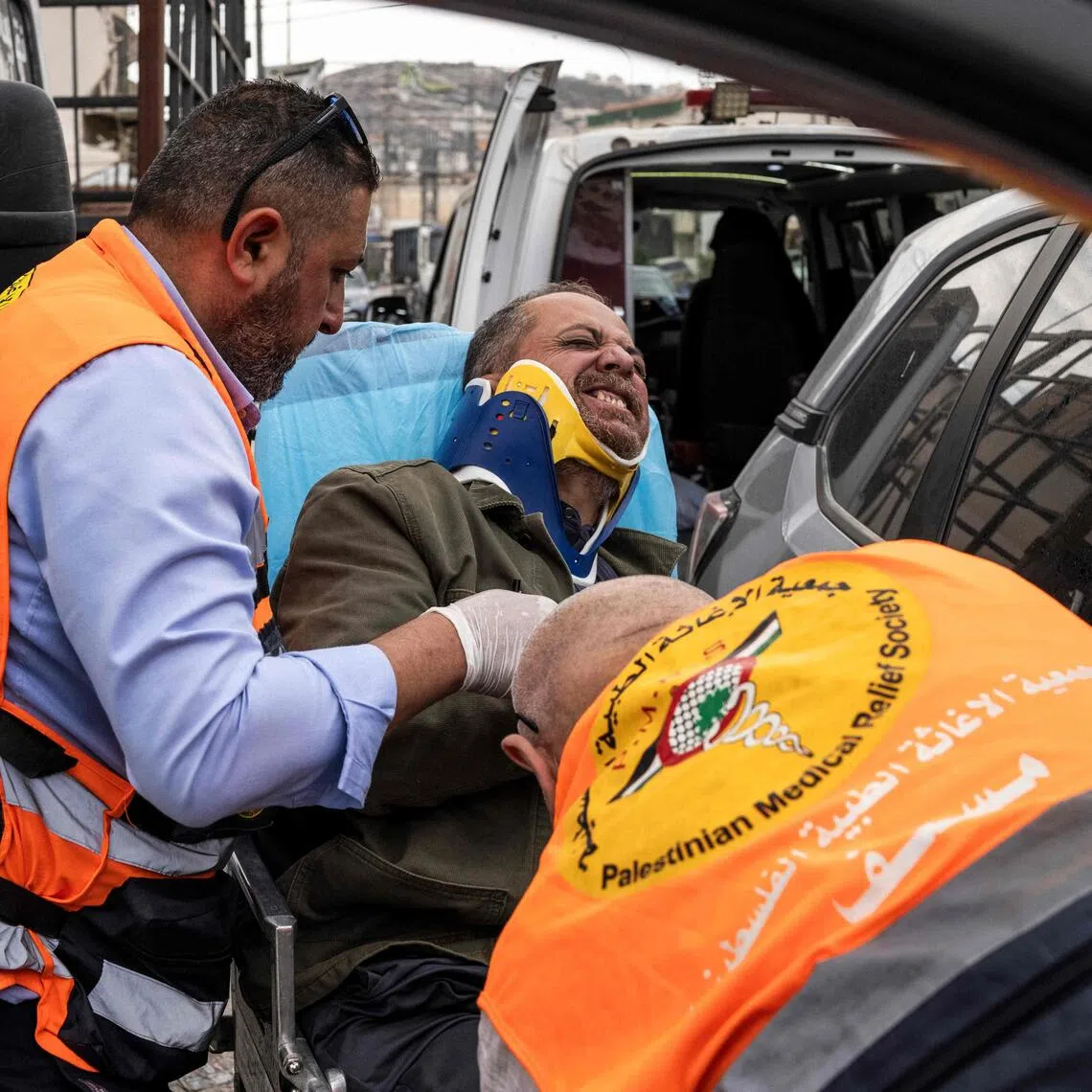 Palestinian first responders taking AFP photographer Jaafar Ashtiyeh to seek medical help on Oct 6, after he was beaten by several Israelis in Aqraba, in the Israeli-occupied West Bank.