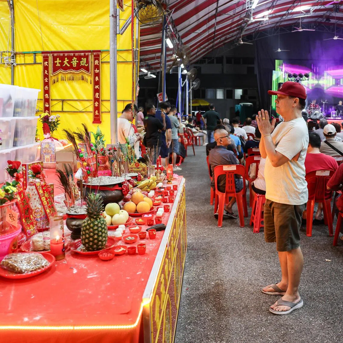 A member of the audience praying at a Hungry Ghost Festival getai show at Toa Payoh Industrial Park on Aug 20.