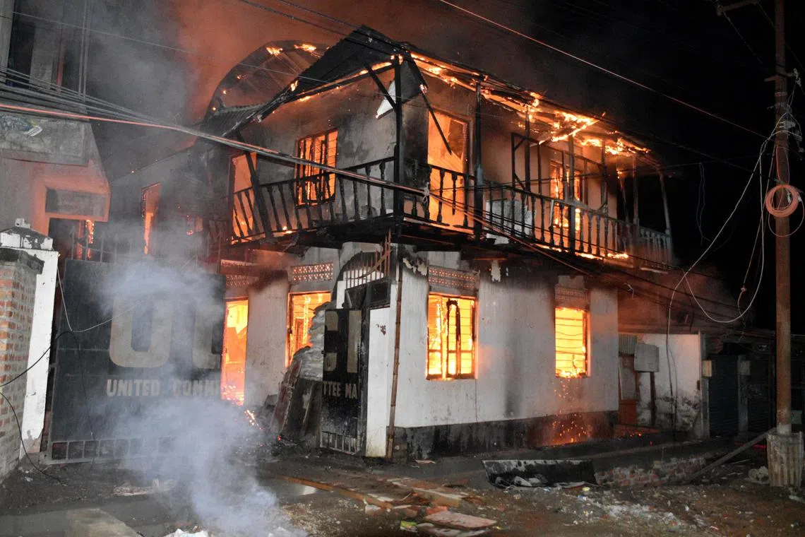 A civil society organisation office building burns after a bomb blast by unidentified men on the campus of a student union in Imphal, Manipur, India, on Feb 23. 