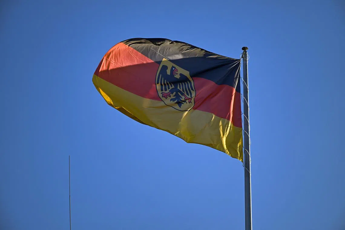 The German flag flutters atop the Finance Ministry building in Berlin on December 5, 2024, ahead of a press conference with the German Finance Minister following a meeting of the Stability Council. (Photo by RALF HIRSCHBERGER / AFP)