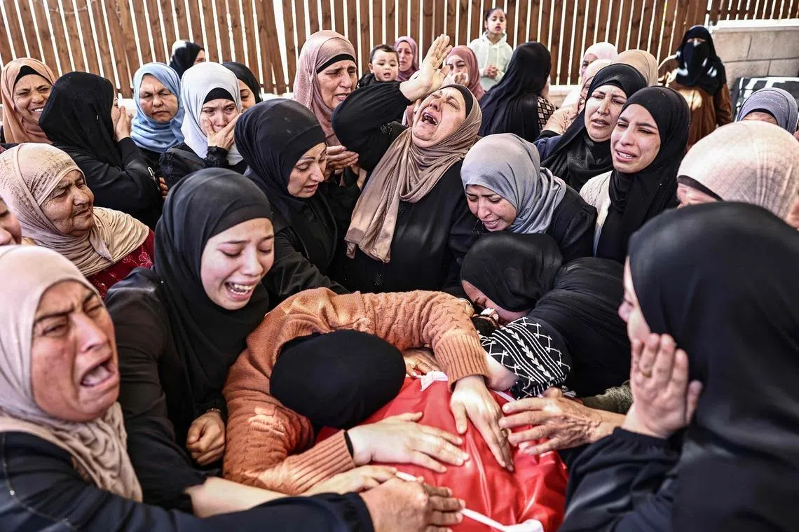 Relatives mourning the death of Jihad Marzouq Abu Naim during his funeral in Al-Mughayyir, east of Ramallah in the Israeli-occupied West Bank, on April 22, 2026. The Palestinian Authority said Israeli settler gunfire killed two Palestinians, including 14-year-old Aws Hamdi Al-Naasan and 32-year-old Jihad Marzouq Abu Naim, both from Al-Mughayyir,  in the central occupied West Bank.