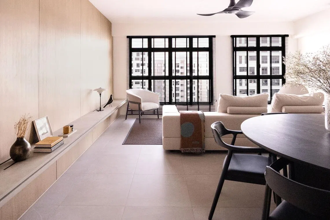 The living and dining rooms feature wood textures and minimalist detailing. 