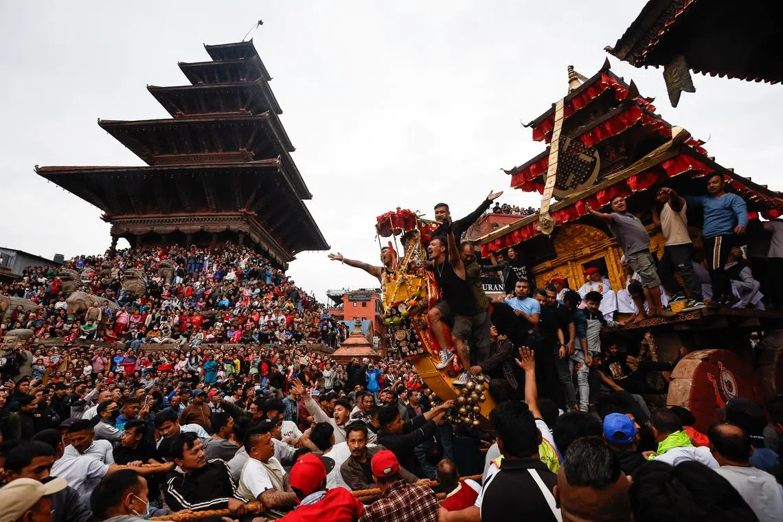 Devotees pulling the chariot of God Bhairab through the city centre during the Biska festival in Bhaktapur, Nepal in April 10, 2025. 