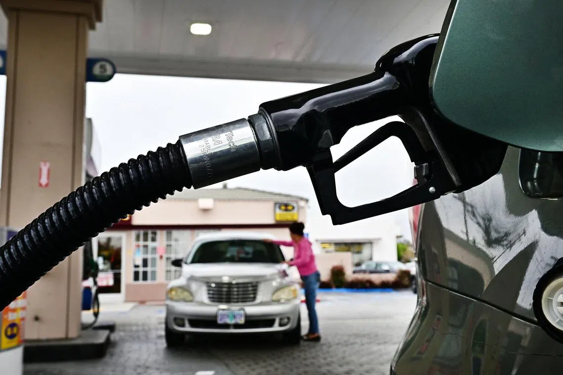 (FILES) Fuel is pumped into a vehicle at a gas station in Montebello, California, on May 15, 2024. Retail sales in the United States slipped less than analysts anticipated in June on a weaker performance in the auto and gas segments, according to Department of Commerce data on July 16, 2024. Sales at auto dealers dropped 2.3 percent from May, while those at gas stations dropped 3.0 percent. Sales at restaurants and bars was up 0.3 percent from a month prior, the Commerce report showed. (Photo by Frederic J. BROWN / AFP)
