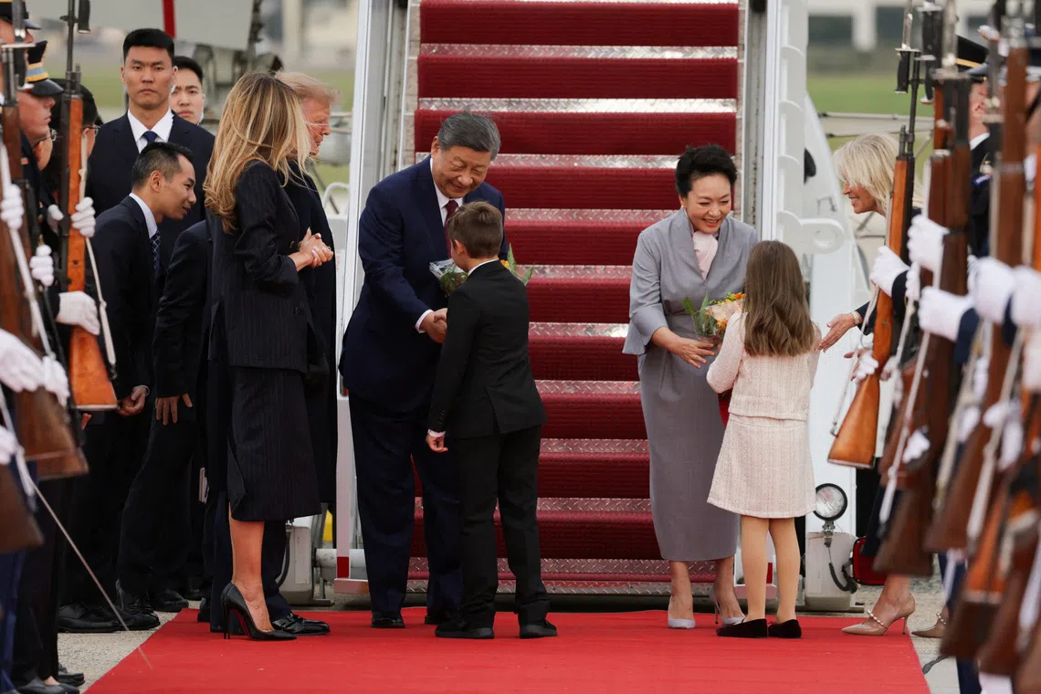 Chinese President Xi Jinping and his wife Peng Liyuan receiving flowers, next to US President Donald Trump and First Lady Melania Trump, upon arriving at Joint Base Andrews in Maryland on Sept 23.