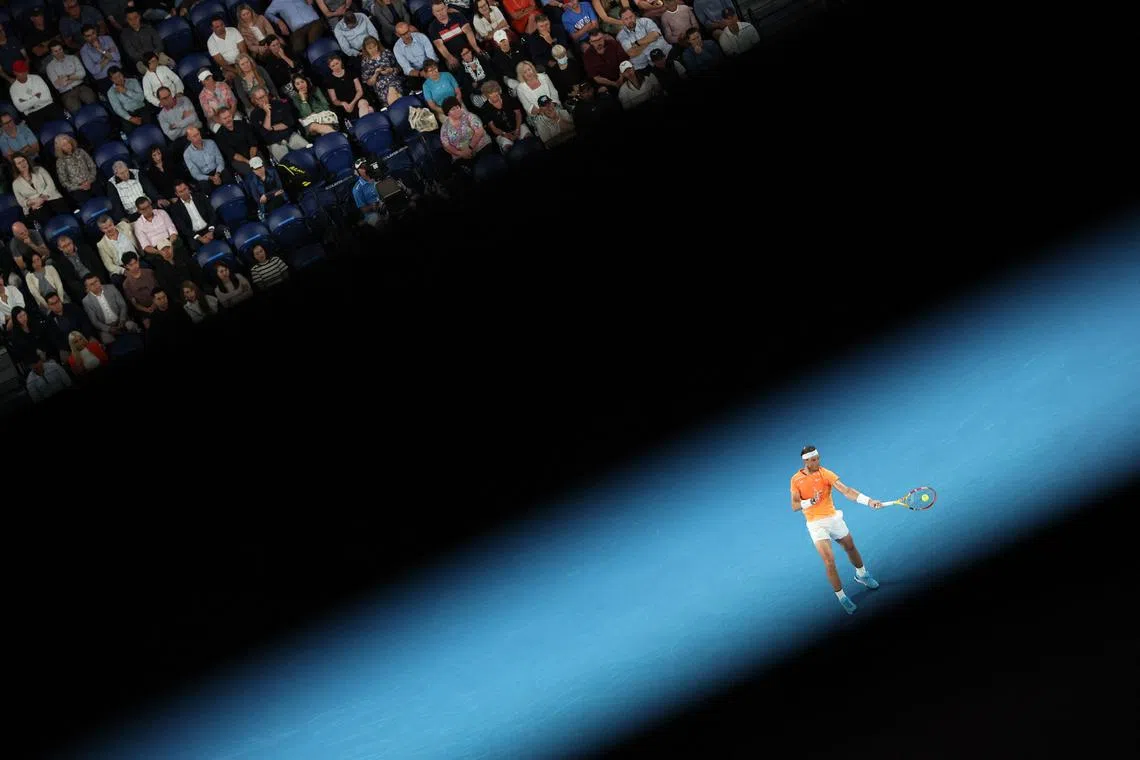 Spain's Rafael Nadal hits a return against USA's Mackenzie McDonald during their men's singles match on day three of the Australian Open tennis tournament in Melbourne on Jan 18, 2023.