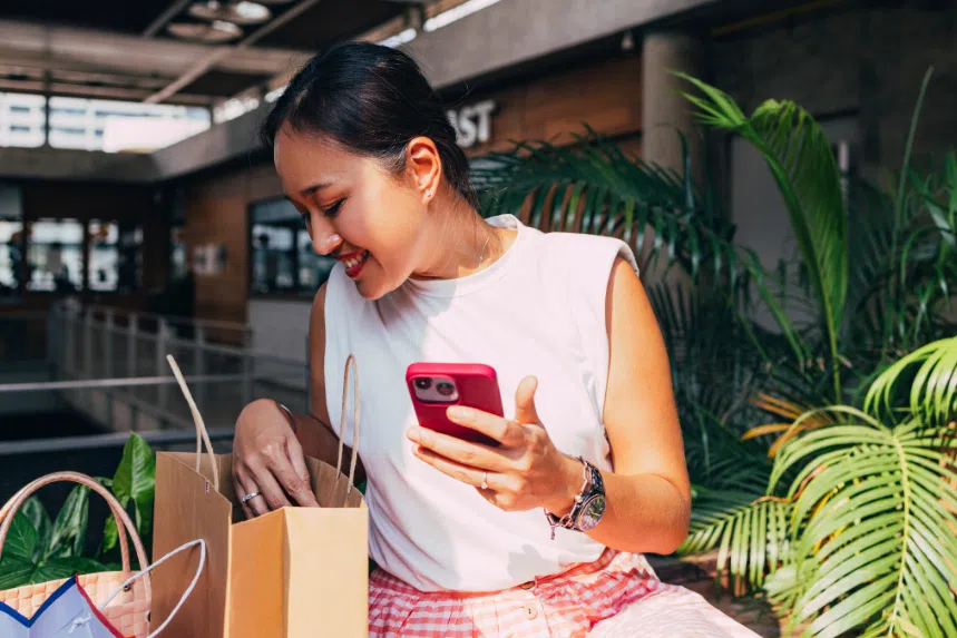Woman looking into her shopping bags