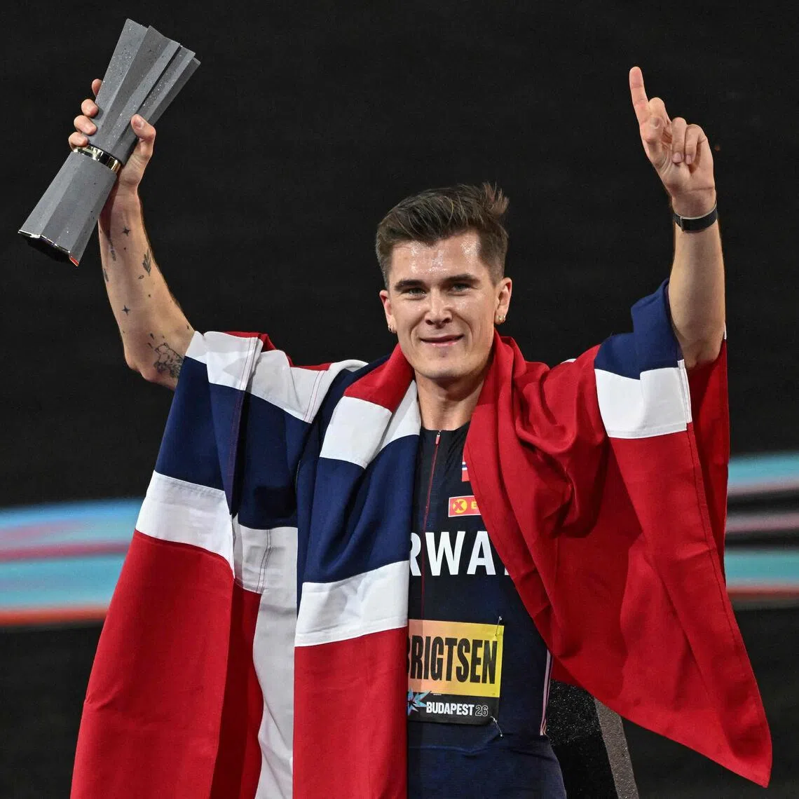 Norway’s Jakob Ingebrigtsen celebrates with the trophy after winning the men’s 5000m final.