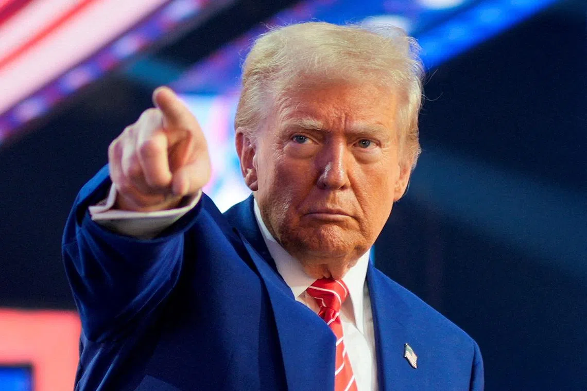 FILE PHOTO: U.S. President-elect Donald Trump gestures at Turning Point USA's AmericaFest in Phoenix, Arizona, U.S., December 22, 2024. REUTERS/Cheney Orr/File Photo
