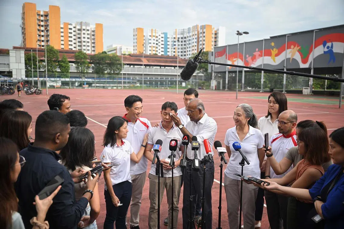 Law and Home Affairs Minister K. Shanmugam wiping the tears off Mr Louis Ng's face during a doorstop, April 22, 2025. Mr Ng announced that he will step away from politics to spend more time with his three daughters.