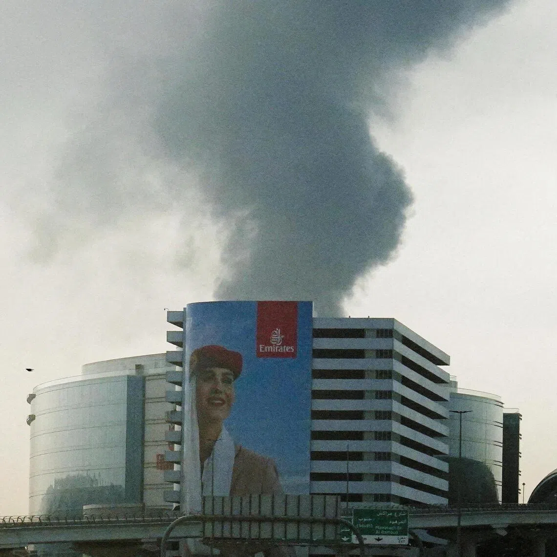 Smoke rising from an area near the Dubai International Airport after a drone attack hit a fuel tank on March 16, 2026.