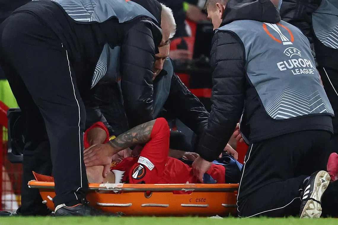 Manchester United's Lisandro Martinez is stretchered off injured during the team's Europa league  match against Sevilla.