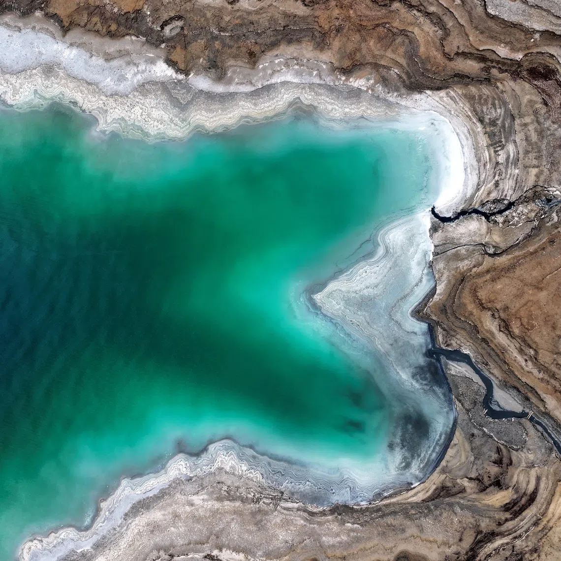 FILE PHOTO: A drone picture shows part of the Dead Sea and its shore near Ein Gedi, Israel, February 7, 2025.  REUTERS/Ilan Rosenberg/File Photo
