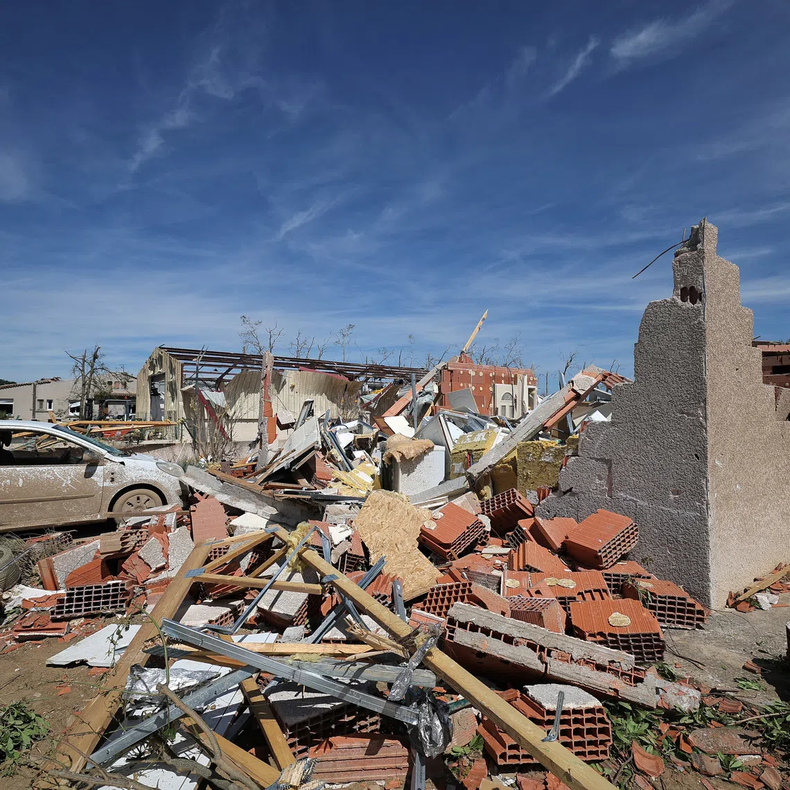 View of a damaged car and debris from destroyed houses a day after a tornado struck the village of Pomas, near Carcassonne, in the Aude department, southern France, August 25, 2026. REUTERS/Manon Cruz