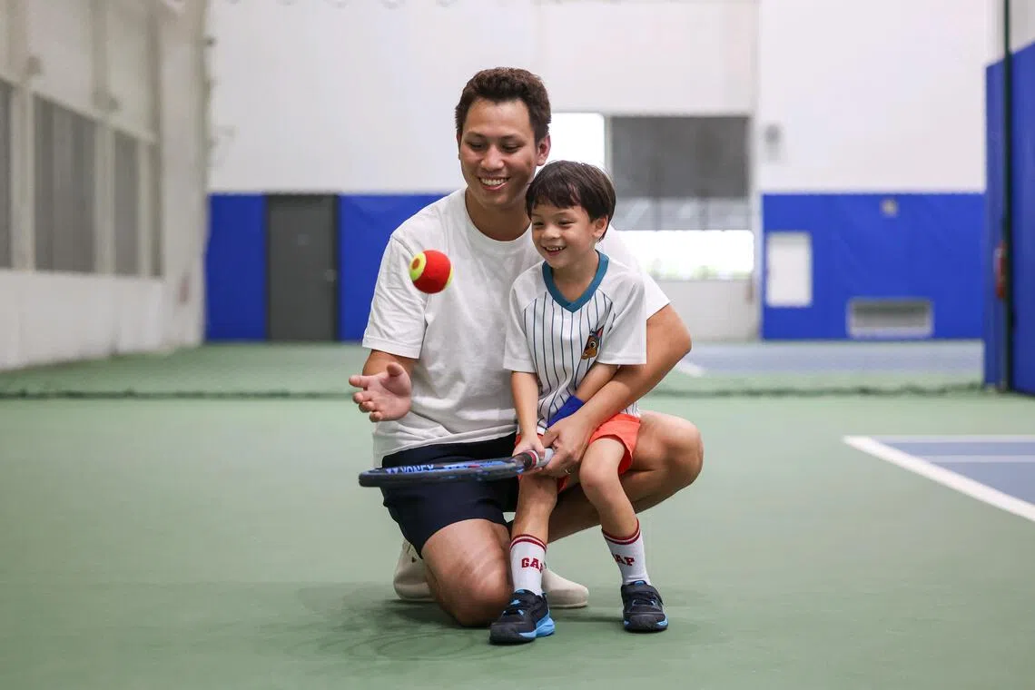 Parent Jason Goh with his son Liam, a participant in the Kallang Kids Tennis Camp.