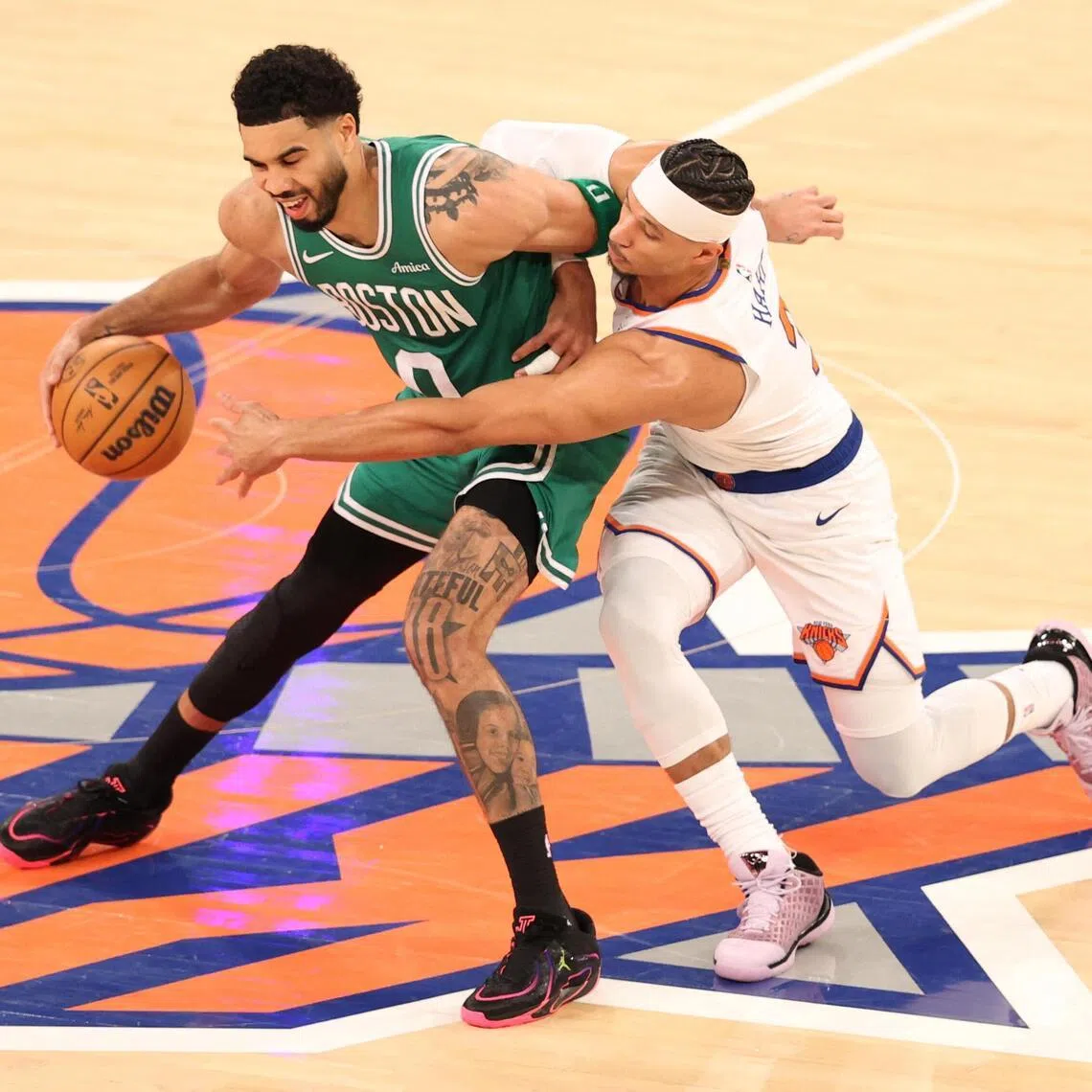 Josh Hart of the New York Knicks attempting to steal the ball from Jayson Tatum during the 112-106 NBA win over the Boston Celtics at Madison Square Garden on April 9, 2026 in New York City. 