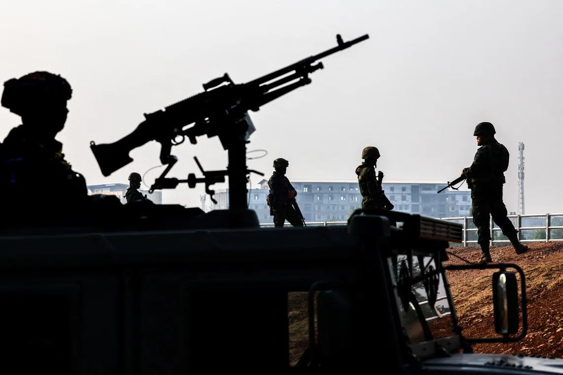 FILE PHOTO: Military personnel stand guard as hundreds of refugees crossed over the river frontier between Myanmar and Thailand on Friday following the fall of a strategic border town to rebels fighting Myanmar's military junta, in Mae Sot, Tak province, Thailand, April 13, 2024. REUTERS/Athit Perawongmetha/File Photo