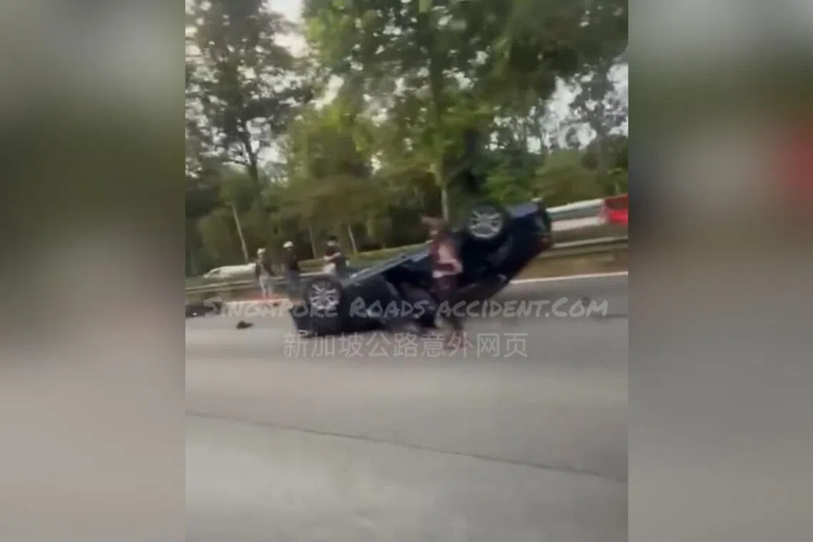 In a video uploaded on a Facebook page, a black car can be seen turned over on the right-most lane of the road.