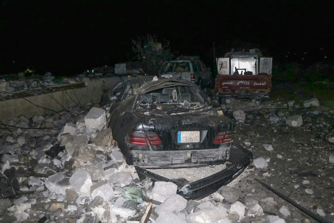 Civil defence vehicles damaged following an overnight Israeli air strike which hit their emergency centre in the southern Lebanese village of Derdghaiya on Oct 10.