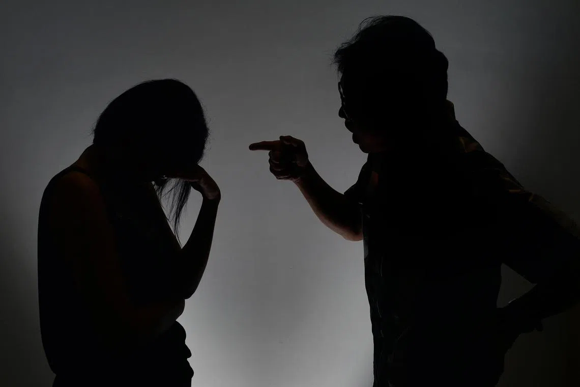 Posed photo of a man scolding a woman to illustrate an article on abusive relationships.