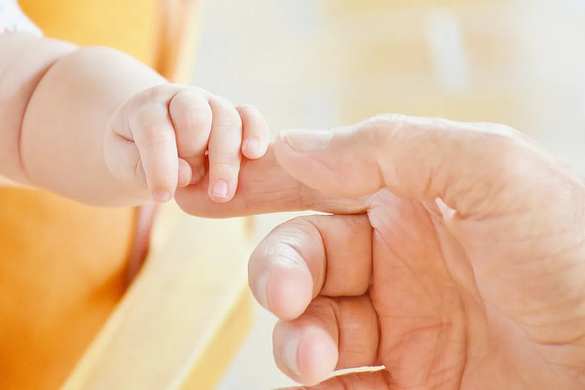 Parenthood is increasingly viewed as the final assurance in life, with individuals delaying it to reduce uncertainty. 