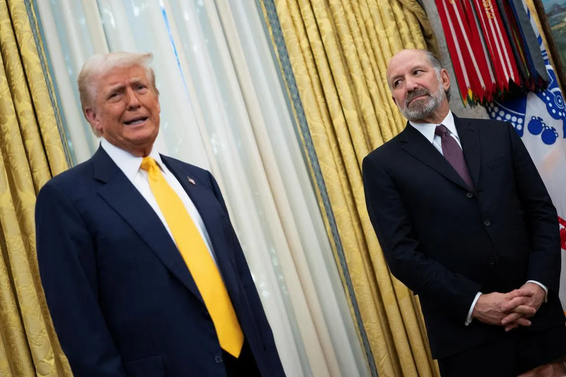 FILE PHOTO: U.S. President Donald Trump speaks alongside Howard Lutnick in the Oval Office of the White House on the day Lutnick is sworn in as U.S. Commerce Secretary by U.S. Vice President JD Vance, in Washington, D.C., U.S., February 21, 2025. REUTERS/Nathan Howard/File Photo