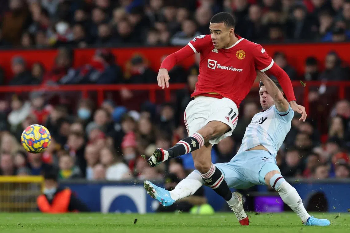 FILE PHOTO: Soccer Football - Premier League - Manchester United v West Ham United - Old Trafford, Manchester, Britain - January 22, 2022 Manchester United's Mason Greenwood in action with West Ham United's Aaron Cresswell REUTERS/Phil Noble