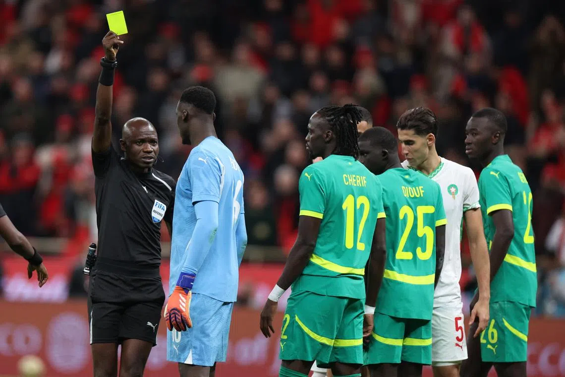 Soccer Football - CAF Africa Cup of Nations - Morocco 2025 - Final - Senegal v Morocco - Prince Moulay Abdellah Stadium, Rabat, Morocco - January 18, 2026 Senegal's Edouard Mendy is shown a yellow card by referee Jean-Jacques Ndala REUTERS/Amr Abdallah Dalsh