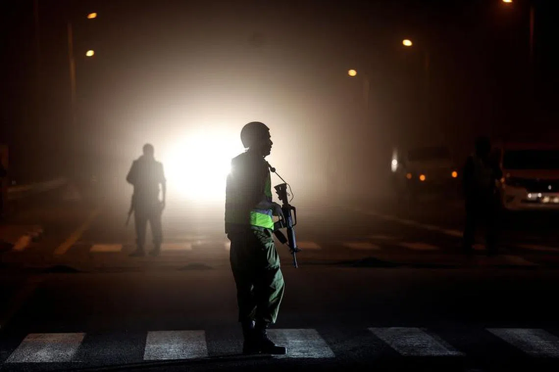 An Israeli soldier is silhouetted on a road near Israel's border with the Gaza Strip, in southern Israel, October 12, 2023. REUTERS/Ronen Zvulun