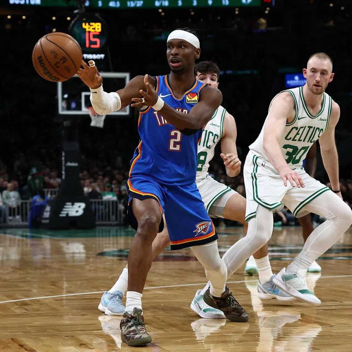 Oklahoma City Thunder guard Shai Gilgeous-Alexander passes out of traffic during the second quarter against the Boston Celtics at TD Garden.
